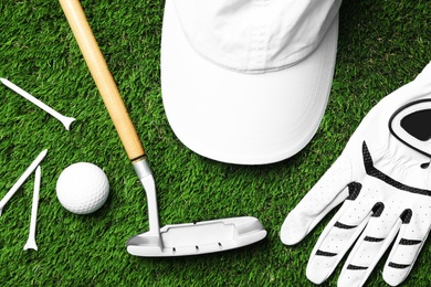 Photo of Flat lay composition with golf equipment on artificial grass