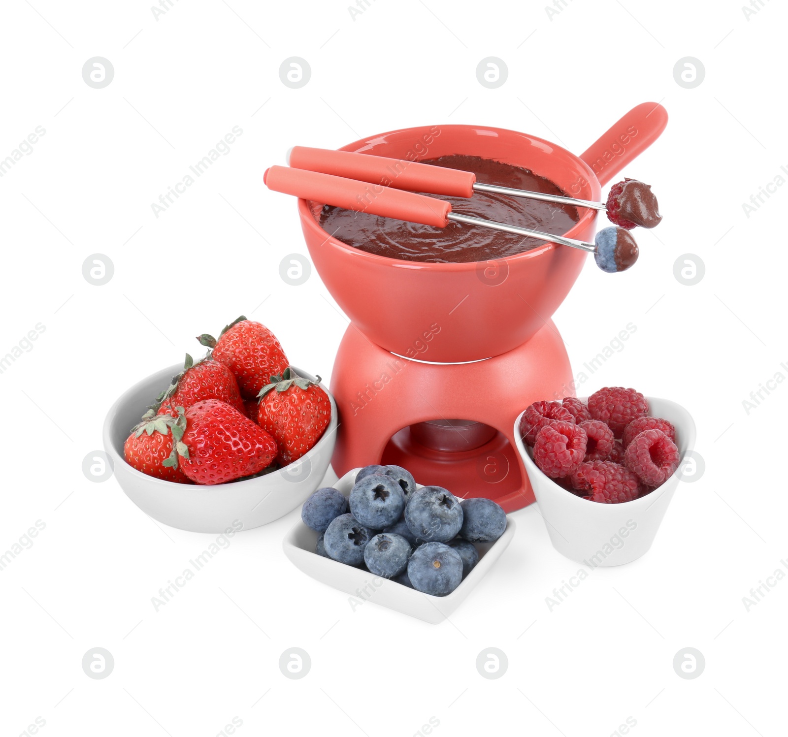 Photo of Fondue pot with melted chocolate, fresh berries and forks isolated on white