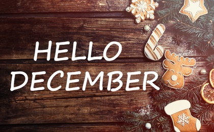 Image of Hello December greeting card. Flat lay composition with tasty Christmas cookies on wooden table