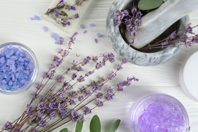 Homemade cosmetic products and fresh ingredients on white wooden table, flat lay