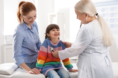 Mother with child visiting doctor in hospital