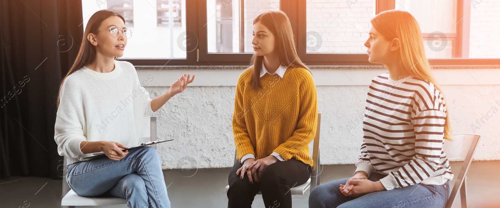 Image of Psychotherapist working with patients in group therapy session indoors. Banner design