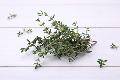 Bunch of fresh thyme on white wooden table