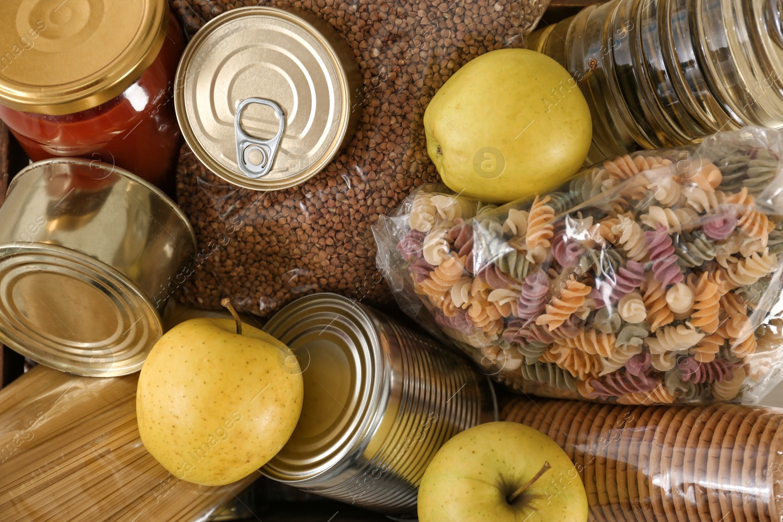 Photo of Donation box with many different products as background, closeup