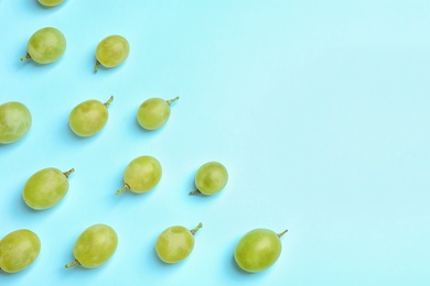 Photo of Fresh ripe juicy green grapes on color background, top view. Space for text