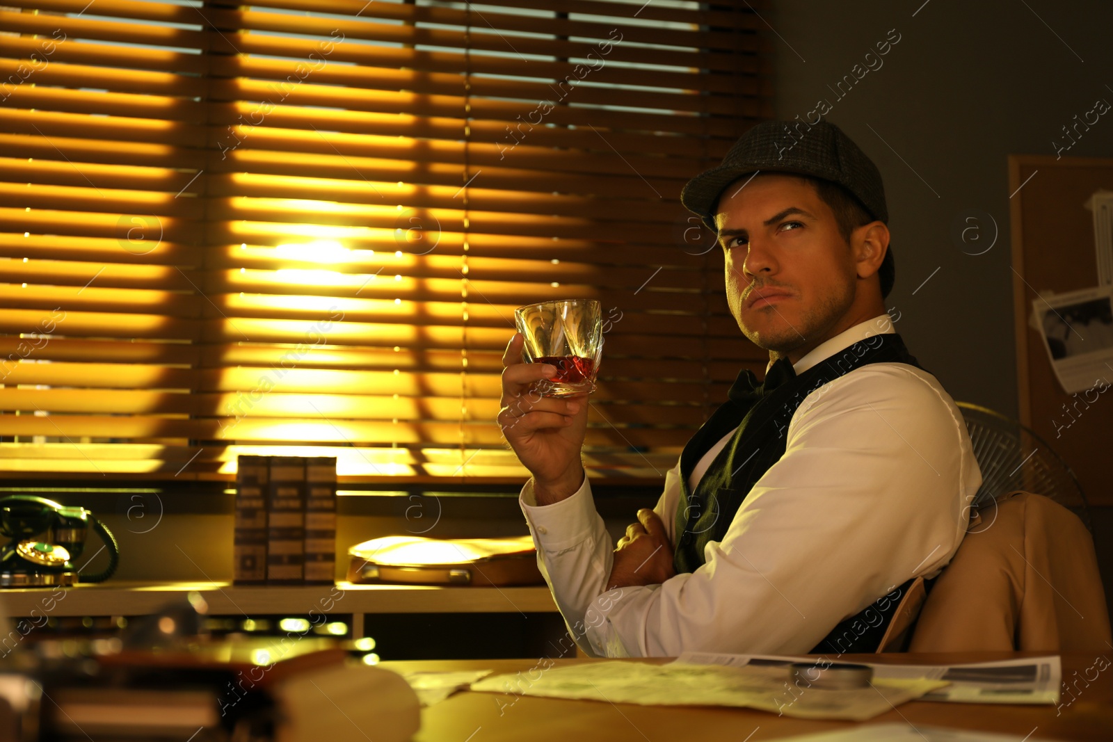 Photo of Old fashioned detective with drink at table in office
