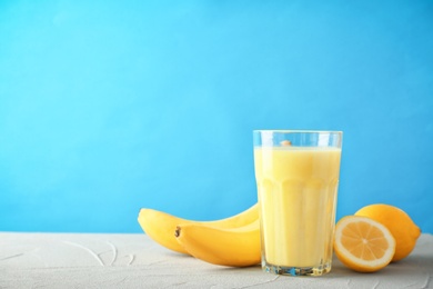 Glass with delicious detox smoothie on table