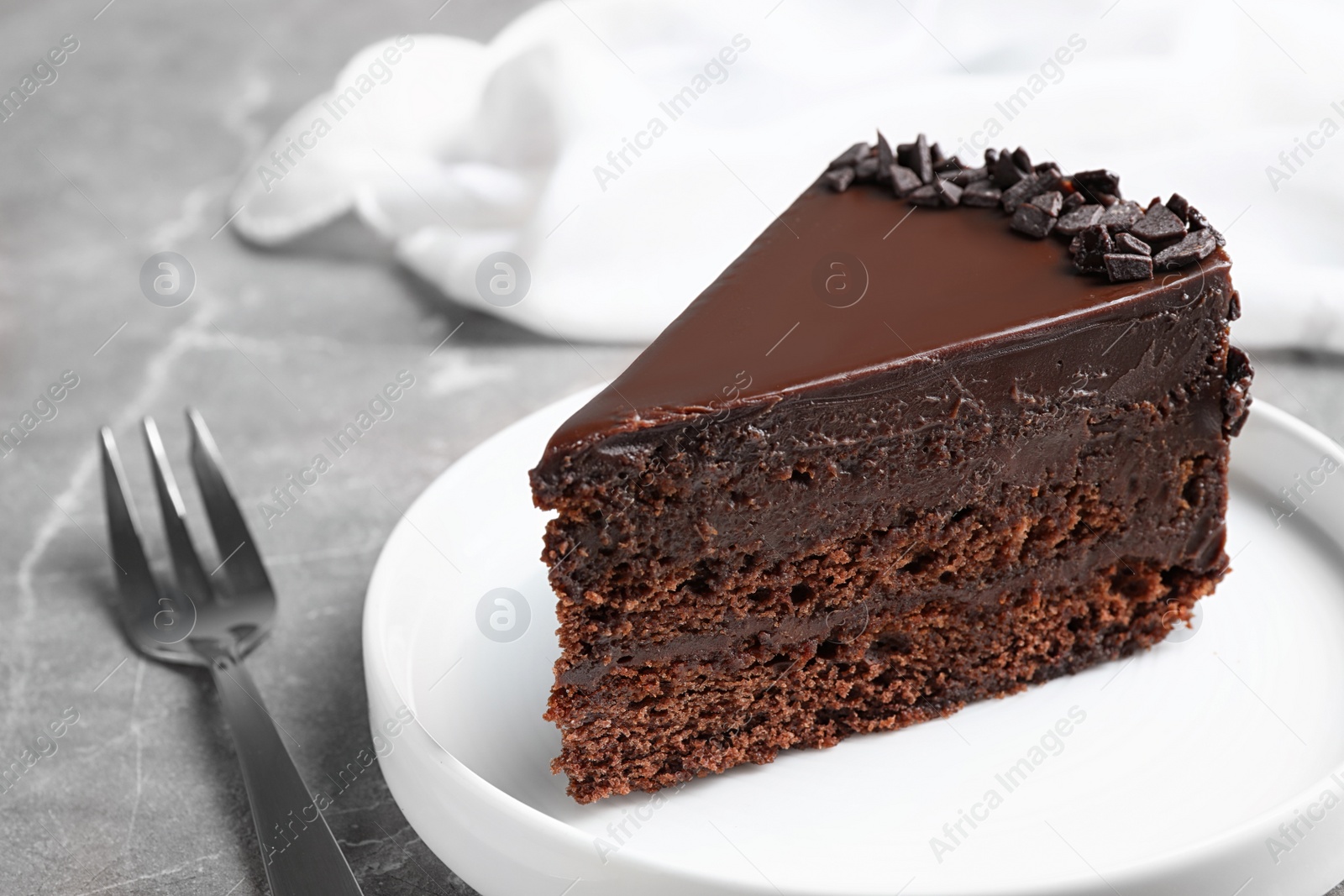 Photo of Delicious fresh chocolate cake served on grey table, closeup