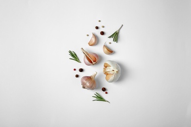 Composition with garlic, pepper and rosemary on white background, top view