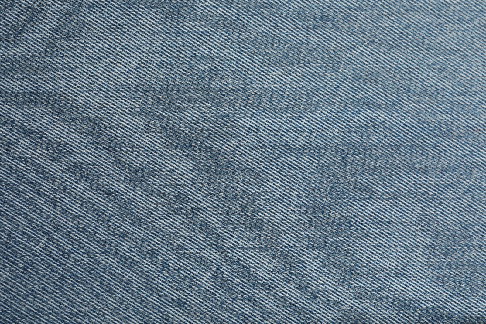 Photo of Texture of blue jeans as background, closeup