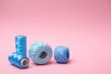 Different sewing threads on color background