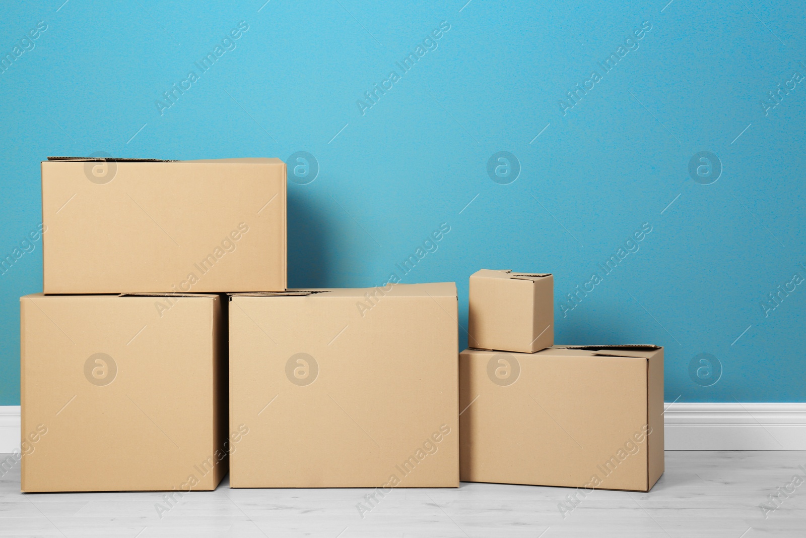 Photo of Cardboard boxes near color wall