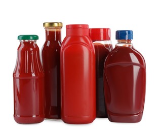 Photo of Different bottles of ketchup on white background