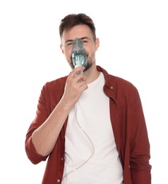 Photo of Man using nebulizer for inhalation on white background