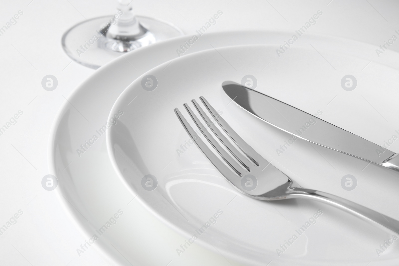 Photo of Beautiful setting with silver cutlery on white table