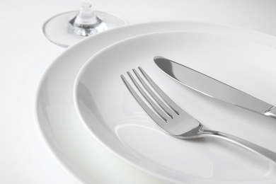 Photo of Beautiful setting with silver cutlery on white table