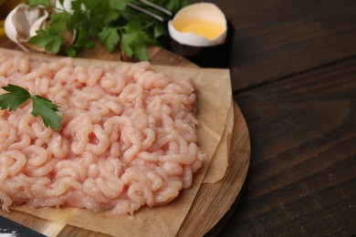 Photo of Fresh raw minced meat on wooden table, closeup. Space for text