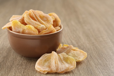 Delicious dried jackfruit slices on wooden table. Space for text