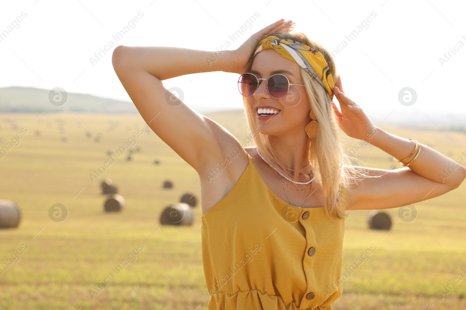 Photo of Portrait of beautiful happy hippie woman in field