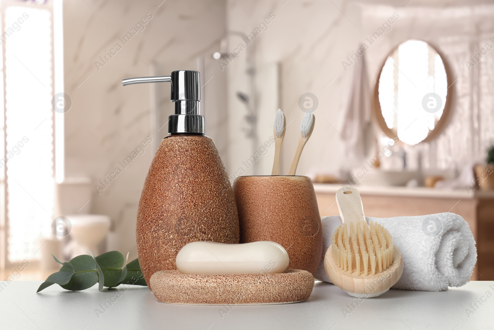 Image of Bath accessories. Different personal care products and eucalyptus leaves on white table in bathroom