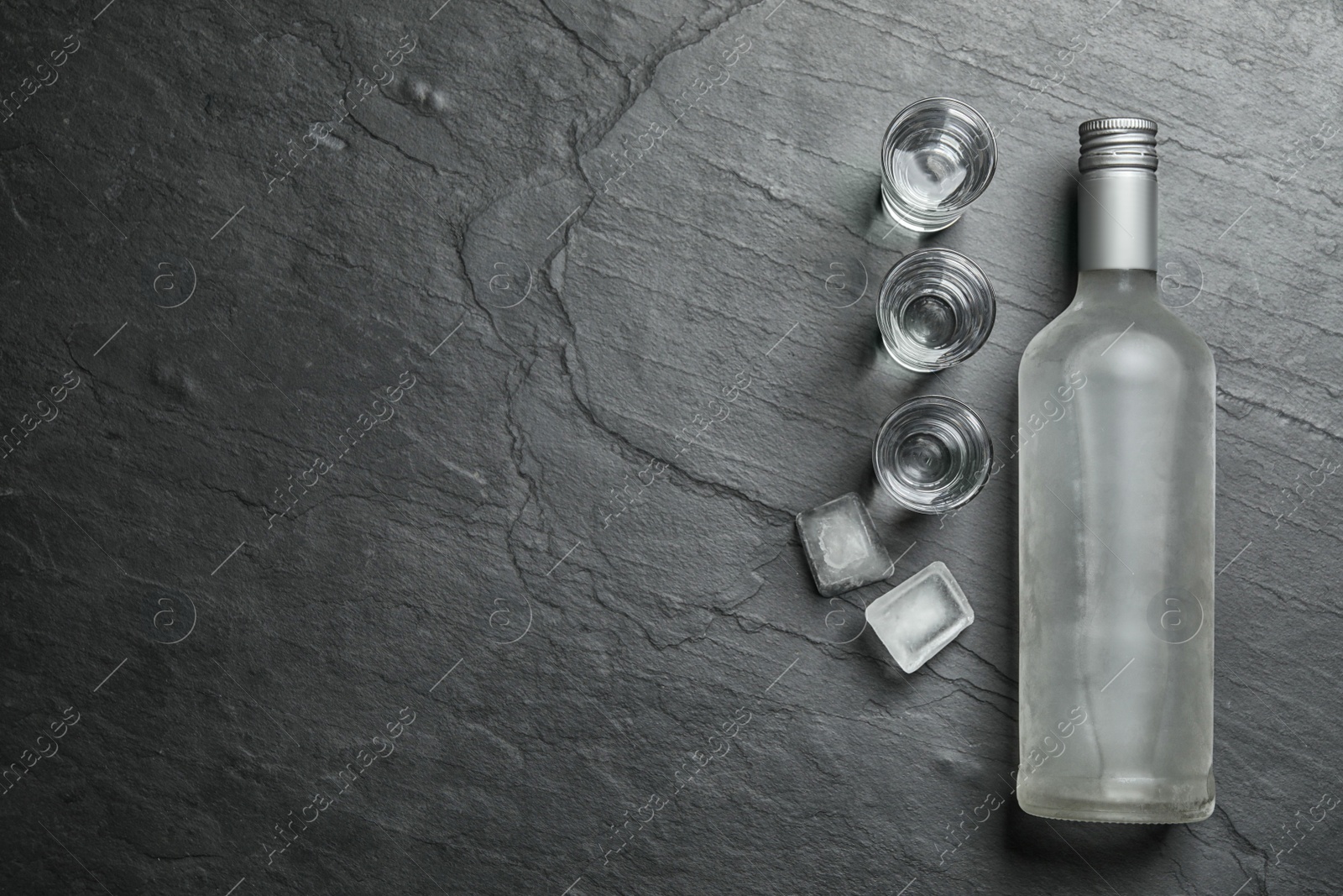 Photo of Cold Russian vodka on black table, flat lay. Space for text