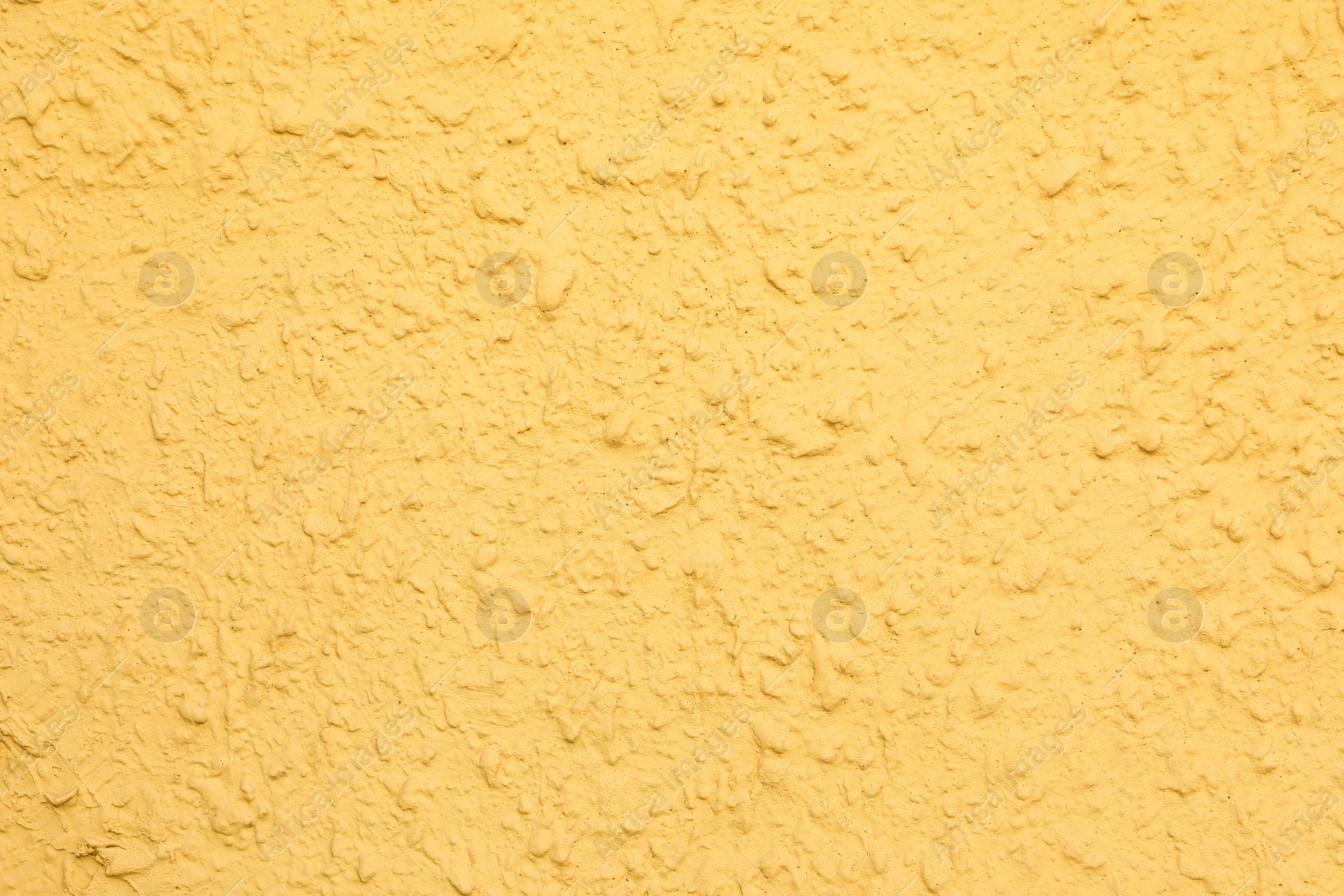 Photo of Texture of yellow plaster wall as background