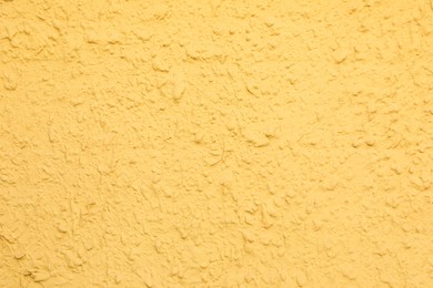 Photo of Texture of yellow plaster wall as background