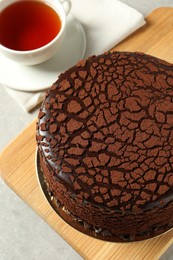 Photo of Delicious chocolate truffle cake on light grey table, above view