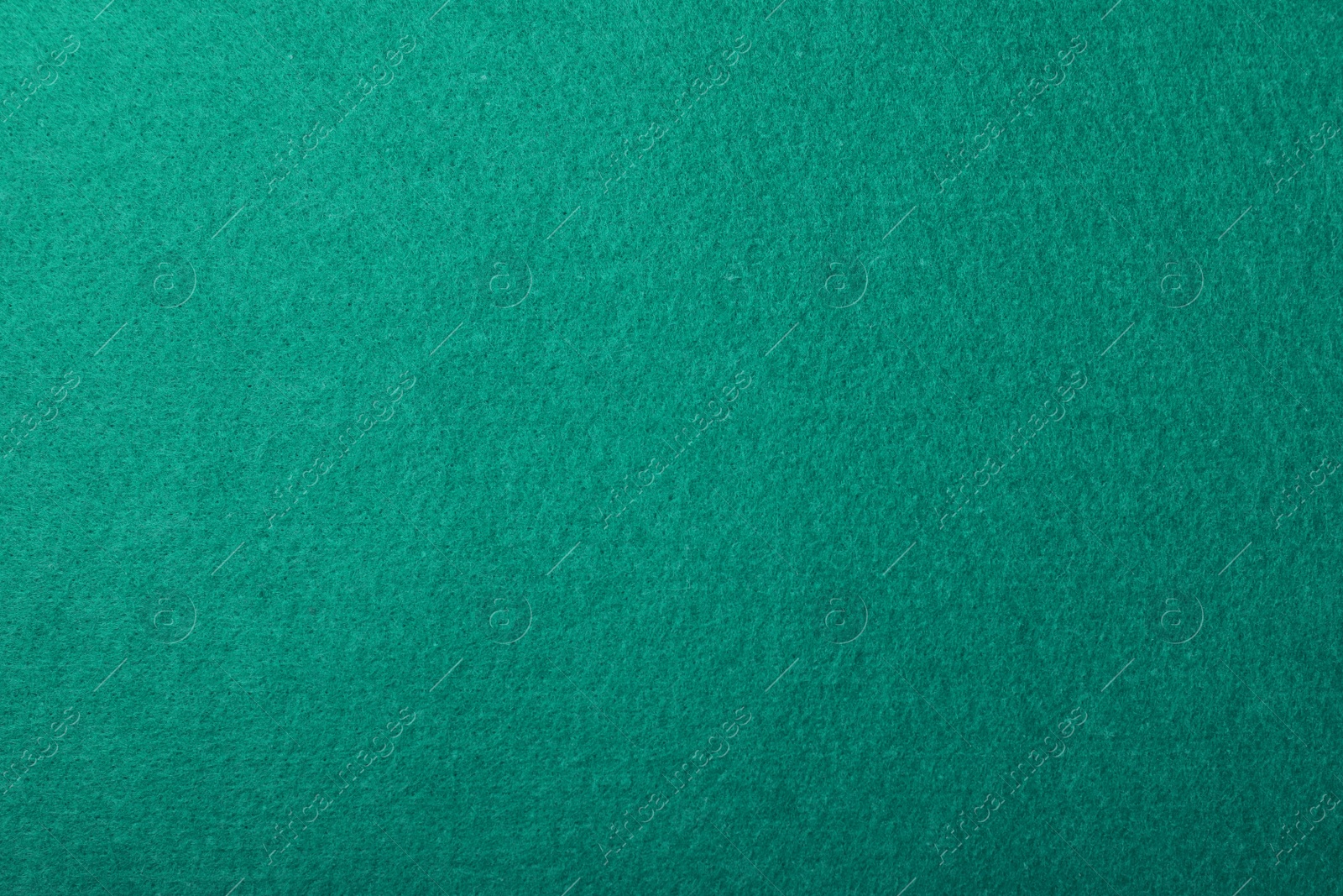 Photo of Texture of green billiard table as background, top view