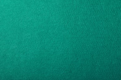 Photo of Texture of green billiard table as background, top view