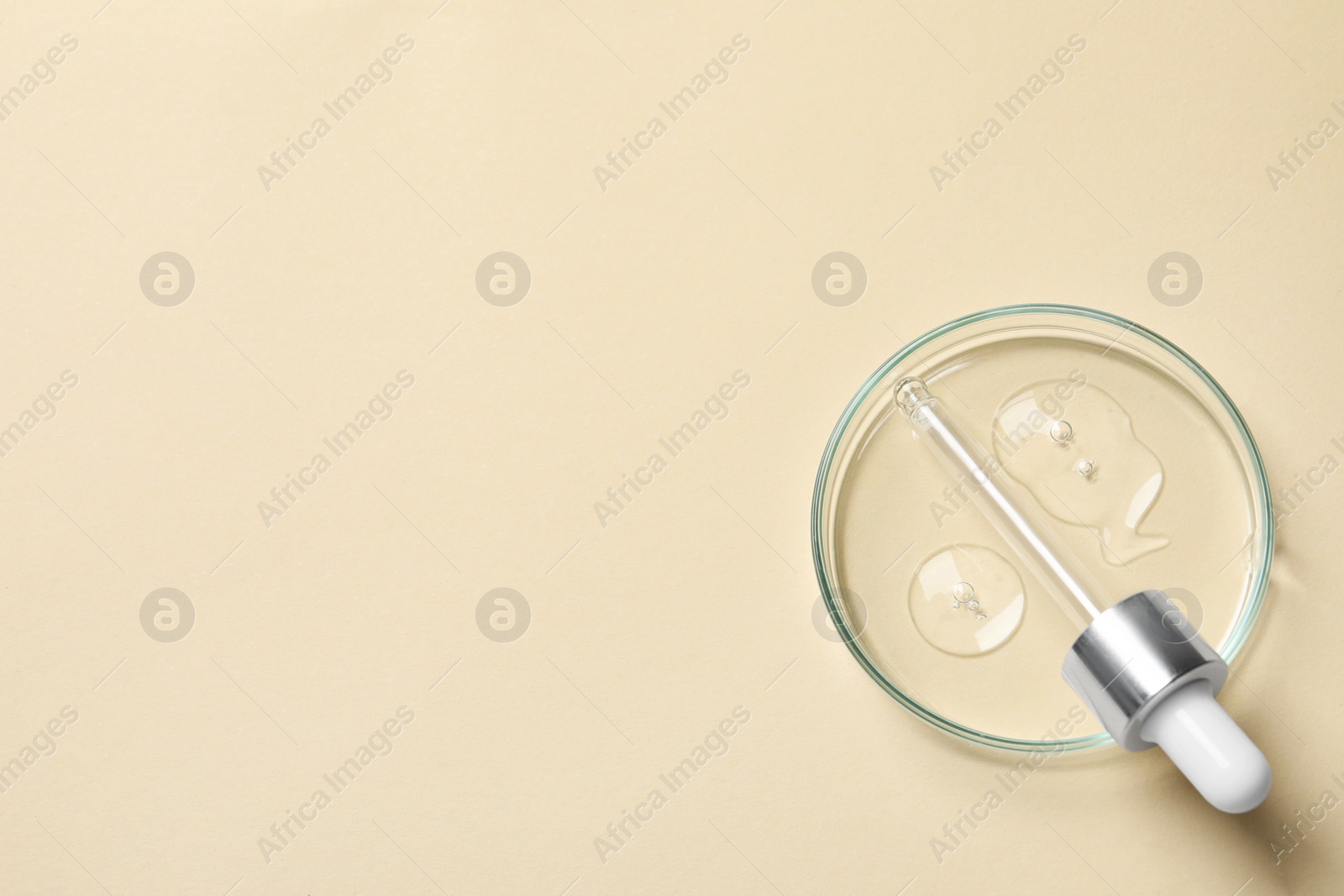 Photo of Petri dish with sample of cosmetic oil and pipette on beige background, top view. Space for text