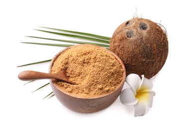 Photo of Coconut sugar in bowl, spoon, fruit and beautiful plumeria flower isolated on white