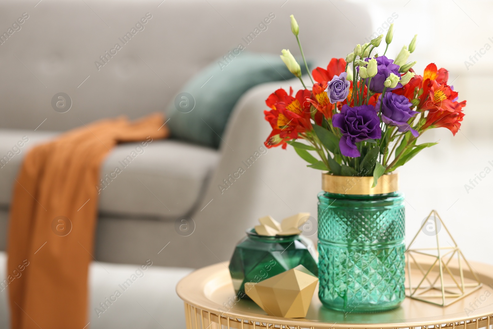 Photo of Glass vase with fresh flowers on table in living room. Space for text