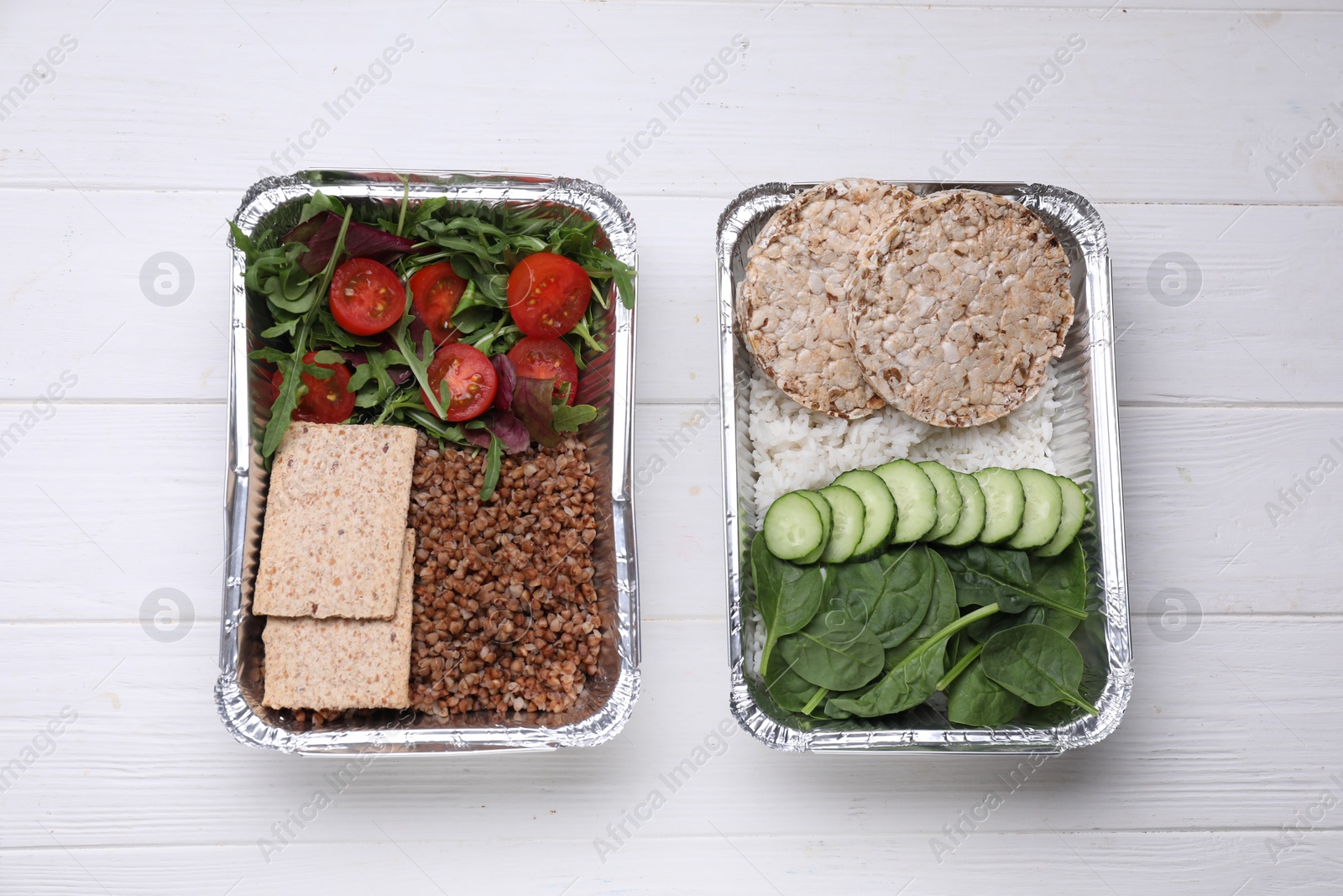 Photo of Containers with different fresh products on white wooden table, flat lay