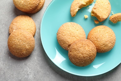 Photo of Plate with Danish butter cookies on grey background, top view