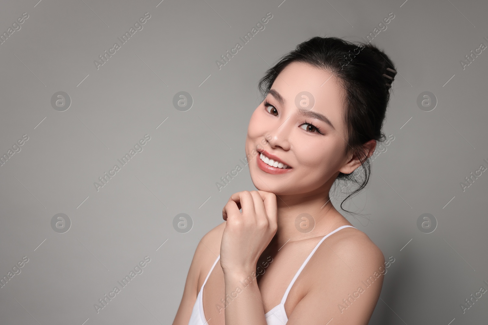 Photo of Portrait of beautiful woman on grey background, space for text