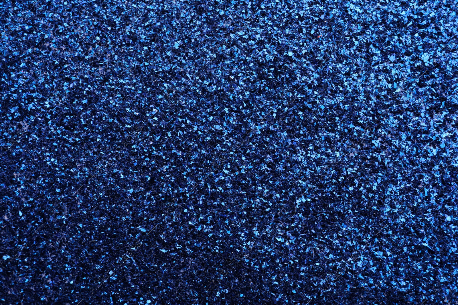 Photo of Beautiful shiny blue glitter as background, closeup