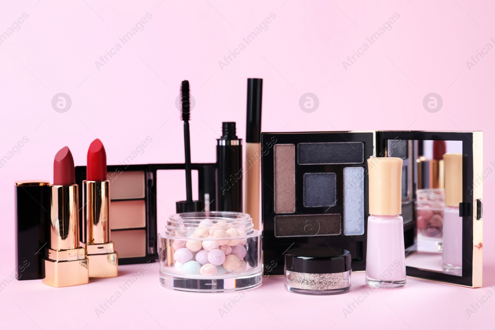 Photo of Different luxury decorative cosmetics on pink background