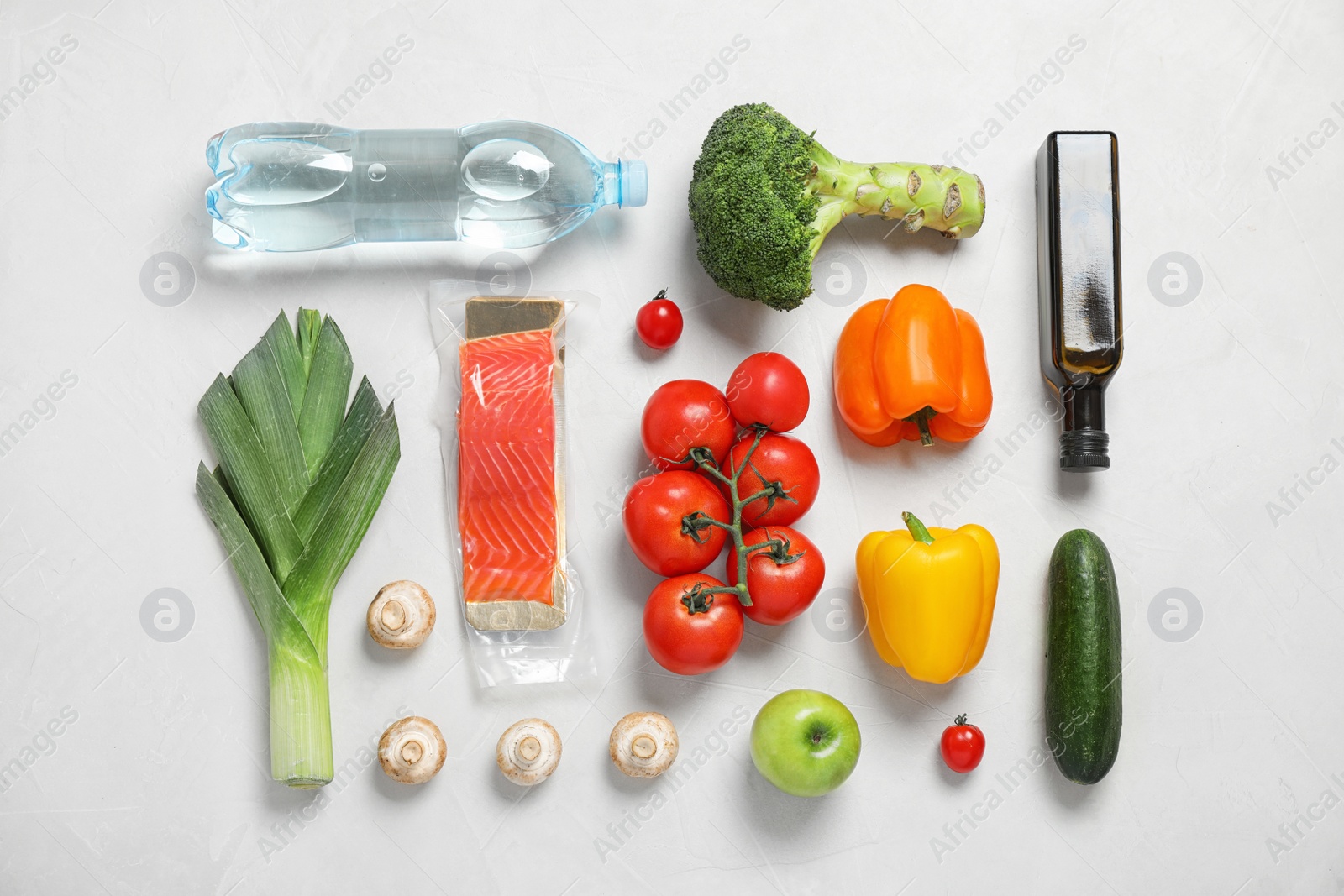 Photo of Fresh vegetables and other products on light grey background, flat lay