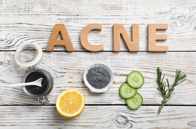 Photo of Word "Acne" and fresh ingredients for homemade problem skin remedy on wooden background