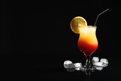 Photo of Just made appetizing cocktail Sex on the Beach, black background. Space for text