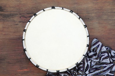 Photo of Modern drum on wooden table, top view