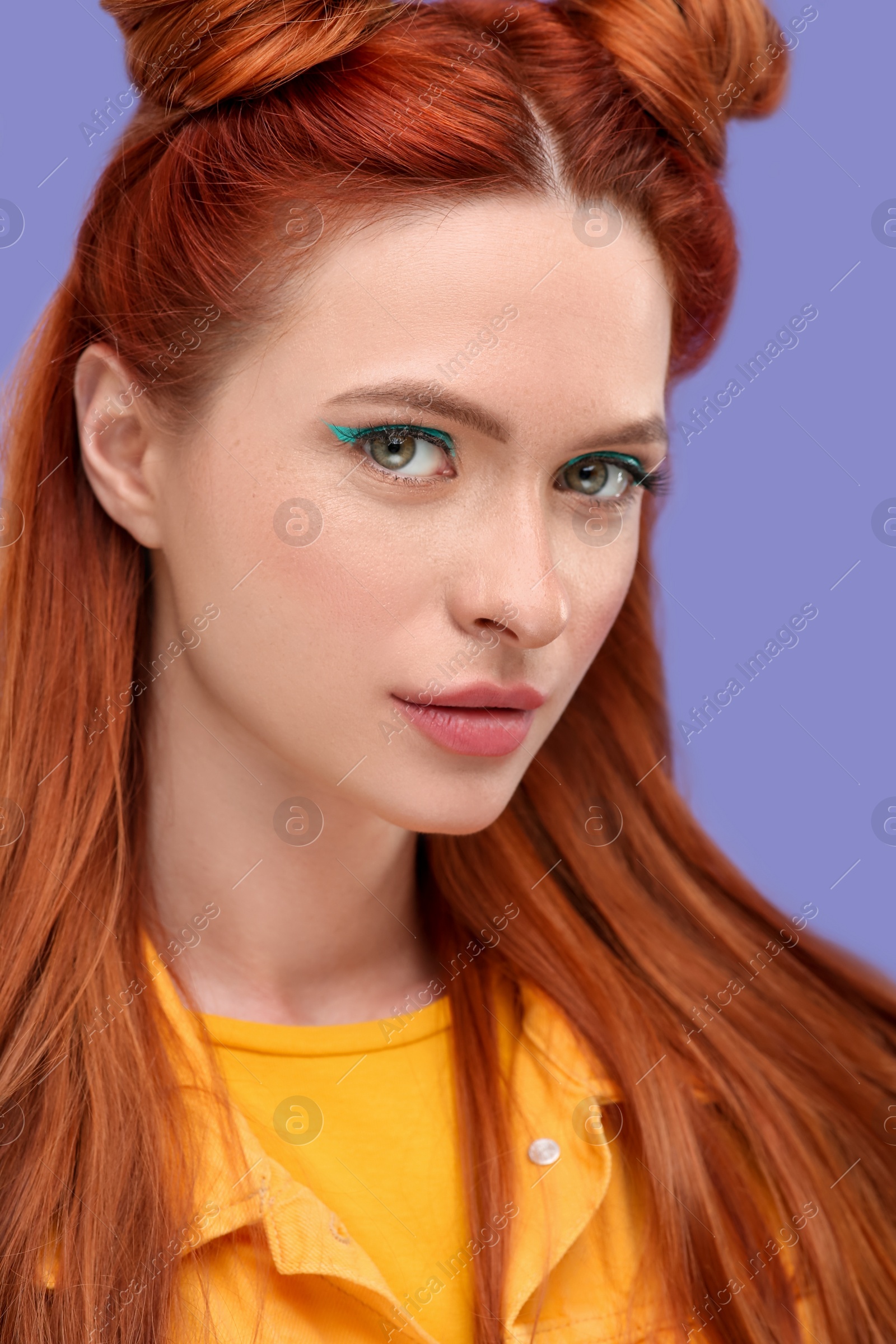 Photo of Portrait of beautiful woman with bright makeup on violet background