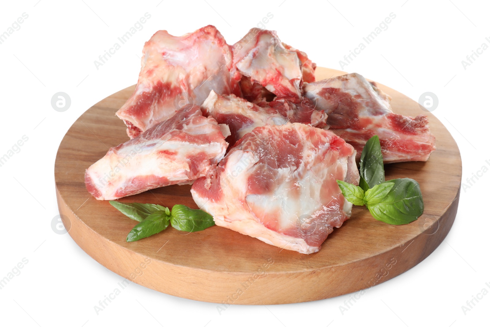 Photo of Raw meaty bones and basil on white background