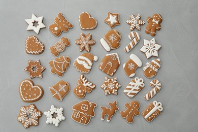 Photo of Different Christmas gingerbread cookies on grey background, flat lay