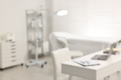 Blurred view of dermatologist's office with examination table