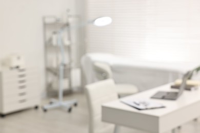 Photo of Blurred view of dermatologist's office with examination table