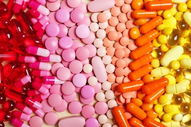 Photo of Different colorful pills as background, top view