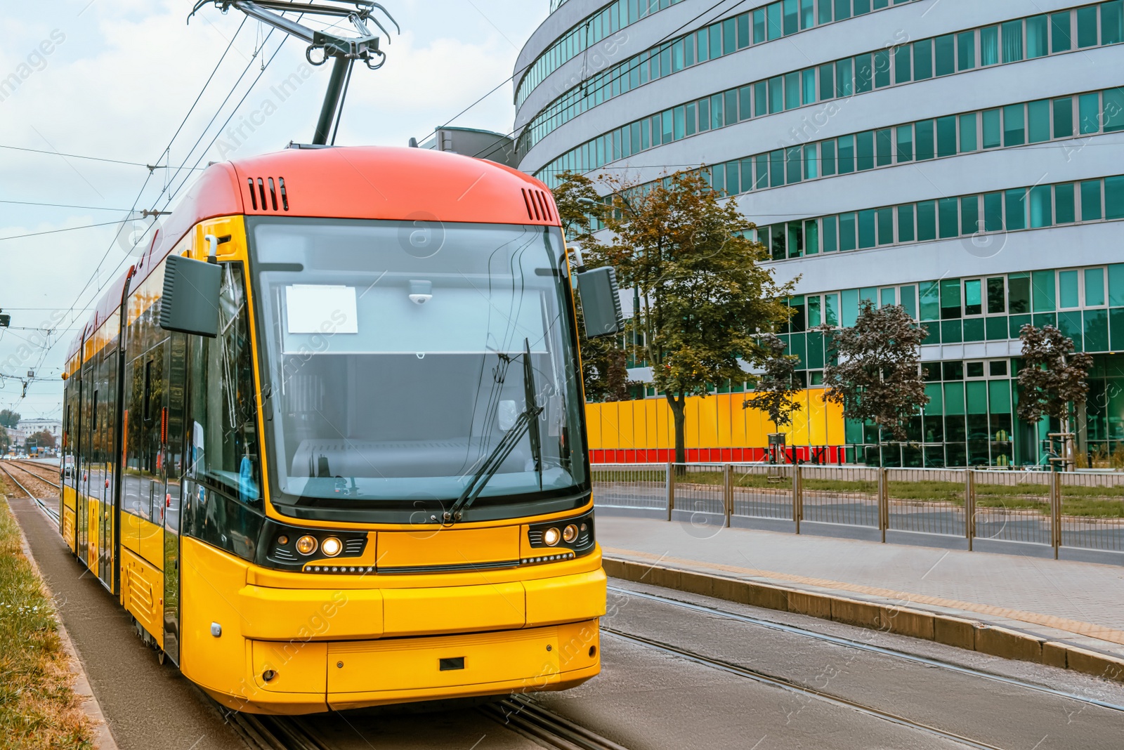 Photo of Modern tram on city street. Public transport