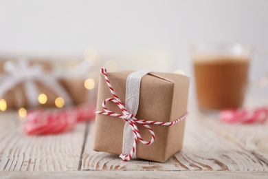 Photo of Christmas gift box on white wooden table, closeup